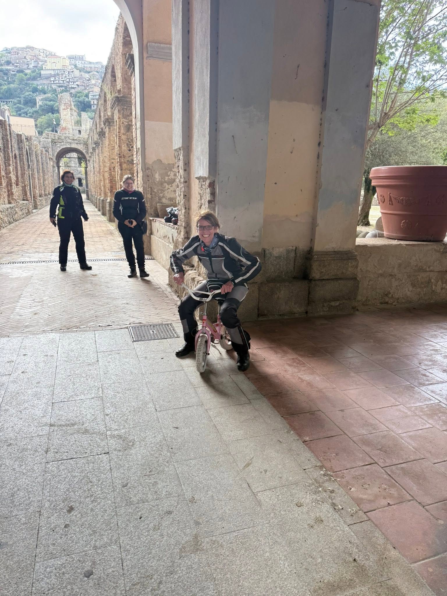 Mitfahrerin auf einem kleinen Fahrrad in der Klosteranlage