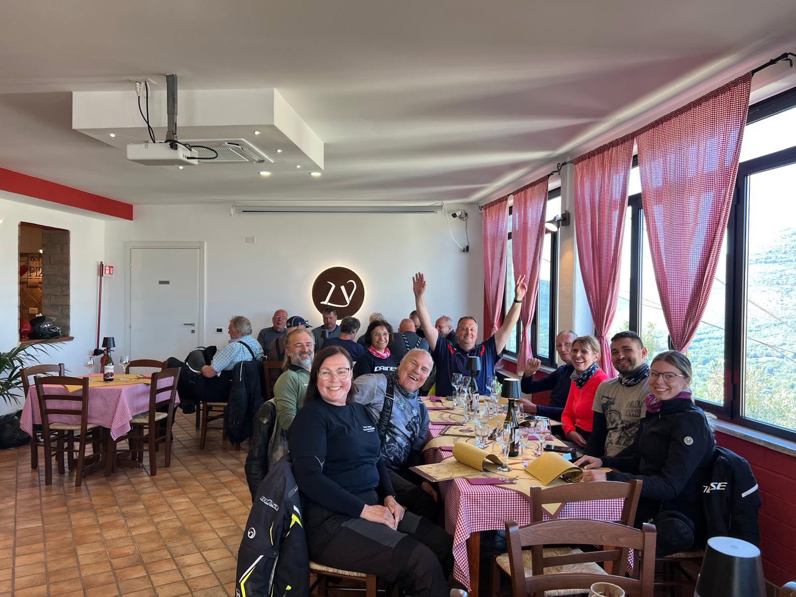 Gut gelaunte Reisegruppe beim Mittagessen in Italien